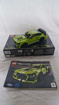 two lego technics are sitting on top of each other