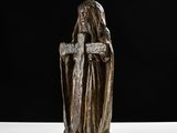 an image of a statue of a woman holding a cross