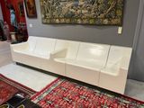 a picture of a living room with a couch and a rug