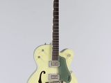 an electric guitar hanging from the ceiling in a white room