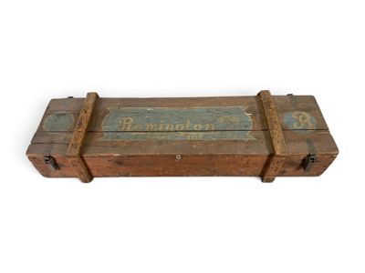 an old wooden box with a sign on it sitting on a white surface