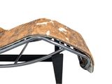 the chaise is made of cowhide and has a metal frame