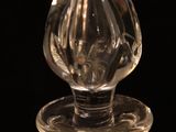 a glass bottle with a glass stopper on top of it