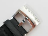 a close up of a watch with a black leather strap