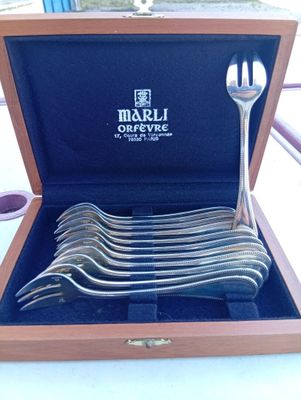six forks in a wooden box on a table