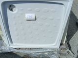 a white microwave sitting on a pallet in a lot