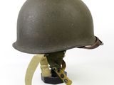 an old military helmet is sitting on top of a table