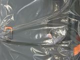 a bag of luggage wrapped in plastic on the floor