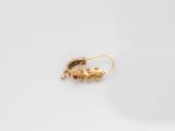 a pair of gold earrings on a white surface
