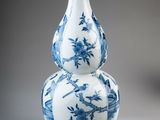 a blue and white vase sitting on top of a table