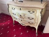 a dresser with a mirror on top of it in a room