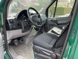 a green truck with a black seat and steering wheel