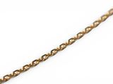 a close up of a gold chain with a diamond on it