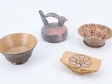 three bowls and a teapot are sitting next to each other