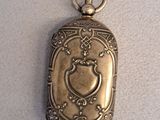 an antique silver locke with a heart on it on a white surface