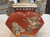 an image of a red heart shaped box sitting on top of a table