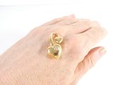 a woman ' s hand holding a gold ring with a diamond