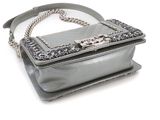 silver handbag with chain strap on white background on white surface