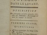 an old book with writing on it sitting on a table