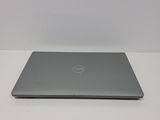 the dell laptop is sitting on a table with a white background