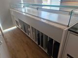 a glass display case in the middle of a room