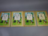 three children ' s books are lined up on a table