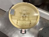 a yellow container sitting on top of a metal table