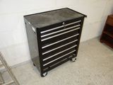 a black tool cabinet sitting in the corner of a room