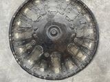 a metal plate with a clock on it on a cement surface