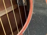 a close up of an acoustic guitar with strings