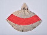 an image of a red and beige striped bag hanging on a white wall