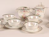 a lot of cups and saucers sitting on a table