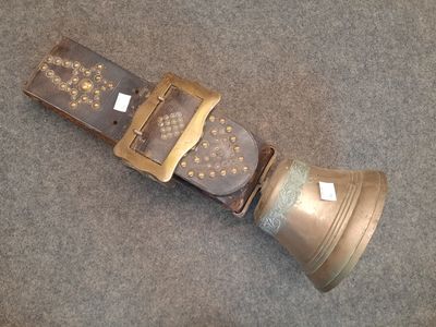 a belt with a bell attached to it on the floor