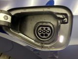 a close up of a car ' s fuel tank with a plug attached to it