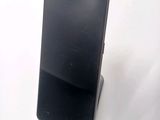 a cell phone that is on a stand on a table