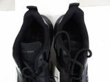 pair of black sneakers with black laces on them on a white surface