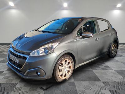 a grey car is parked in a room with a checkered floor