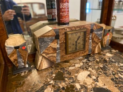 someone is taking a picture of a table with a clock and a beer