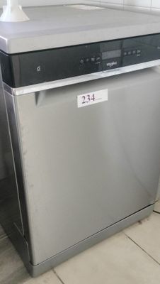 a dishwasher that is sitting in the corner of a kitchen