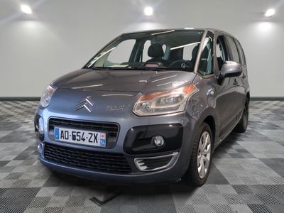 the grey citrole is parked on a checkered tile floor