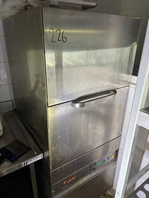 a stainless steel refrigerator in the corner of a kitchen
