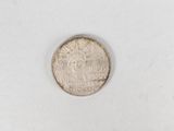 an image of a small coin on a white surface