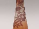 a glass vase with a brown and white design on it