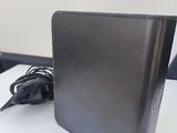 a laptop computer sitting on a table with a charger
