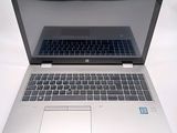a laptop computer that is open on a white surface