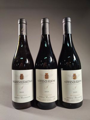 three bottles of wine sitting on top of a table next to each other
