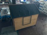 a dog house with a black roof in a store