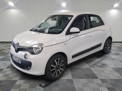 a picture of a white smart car parked in a garage
