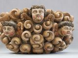 a sculpture of a group of people made of wood