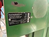 a close up of a green machine with a sticker on it